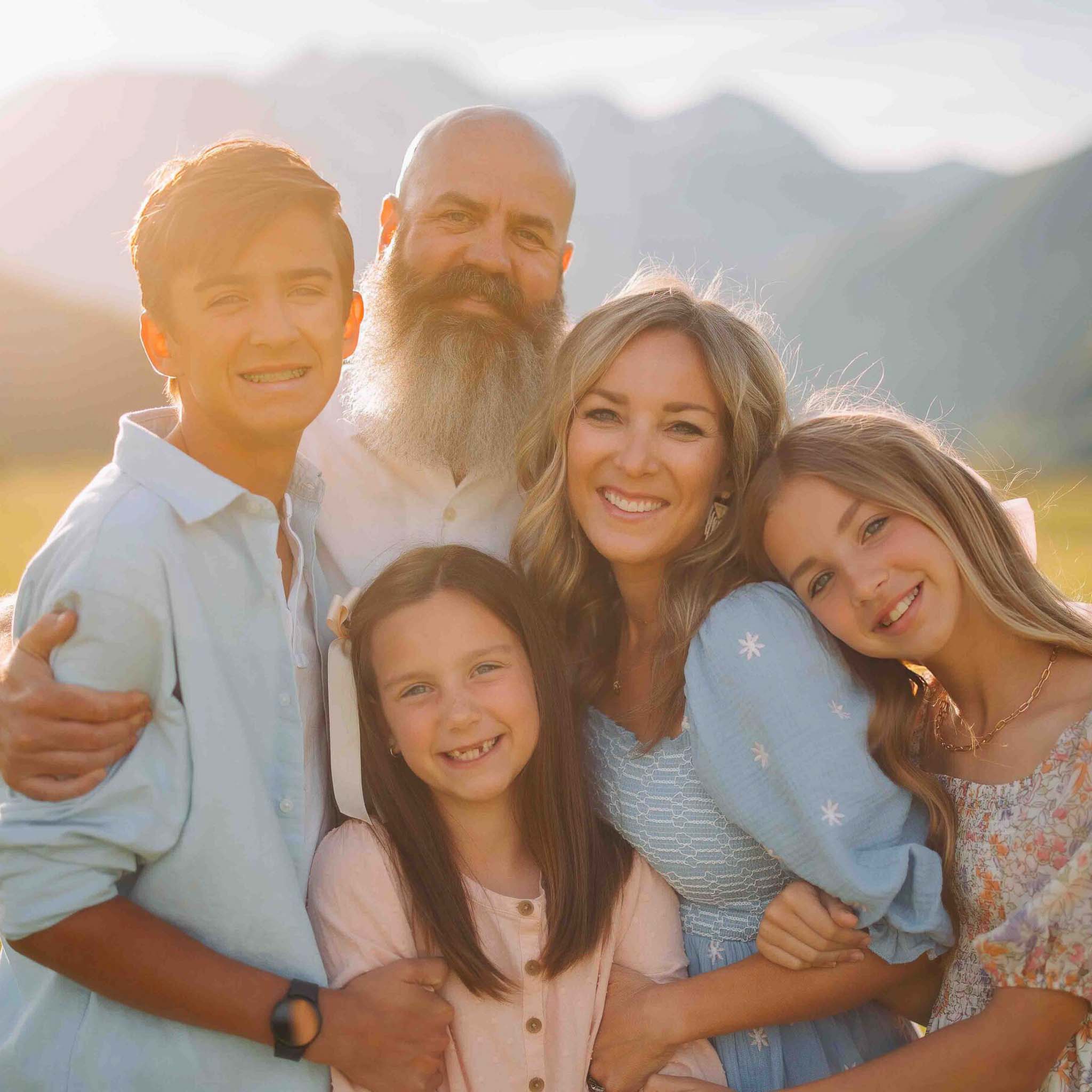 young family posing for family photos in provo utah golden hour in a golden field. hawkins photo and film family photography