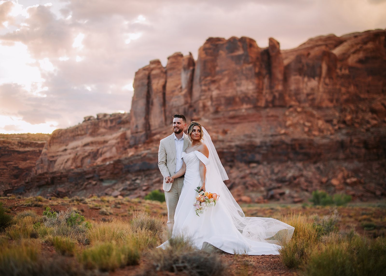 Jordan and Tyler Bride and Groom redrock moab utah red earth venue bridals formals photographer hawkins photo and film golden hour