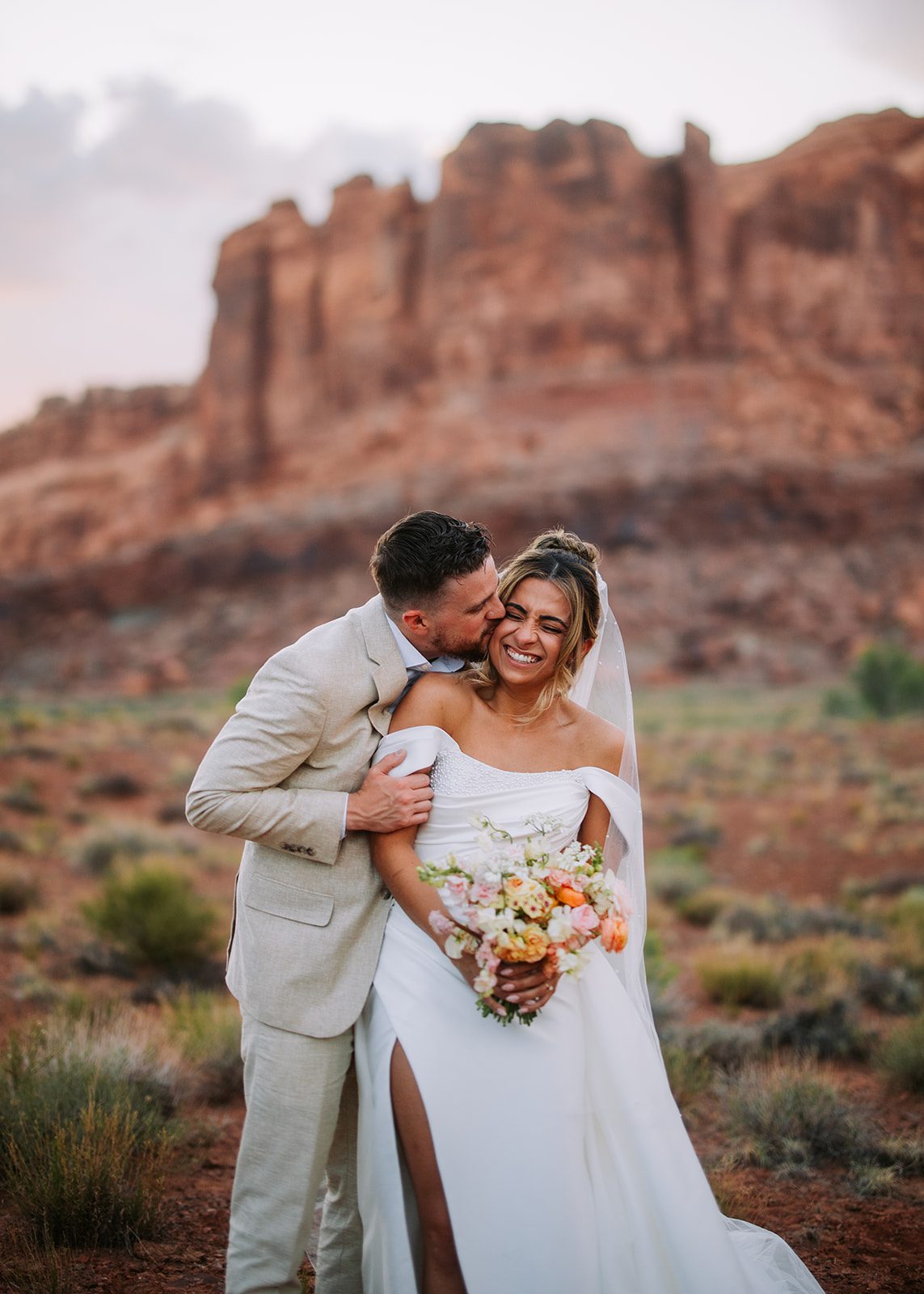 young couple wedding in moab utah at red earth venue near dead horse point. Utah destination wedding photographer hawkins photo and film